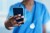 Closeup shot of an unrecognizable nurse using a cellphone in a hospital