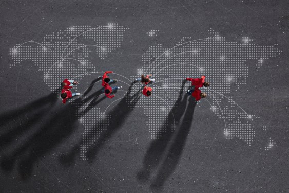 Image of four pairs of individuals walking over a map of the world with interconnected points to represent the global impact of investing in diverse founders and companies.