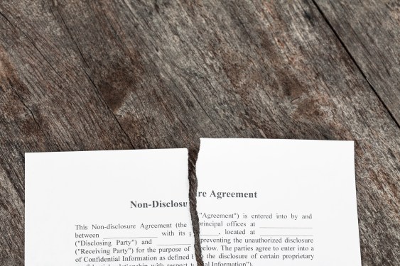 Image of a non-disclosure agreement torn in half.