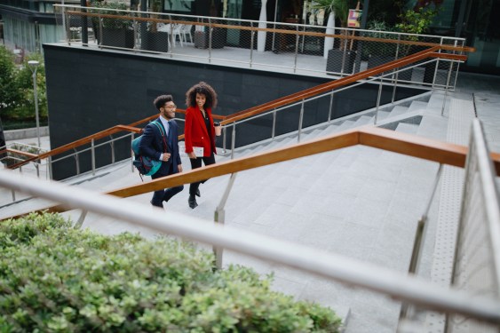 Two coworkers climbing up the stairs