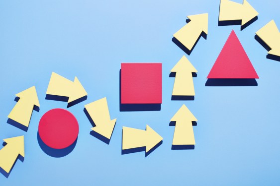 illustration showing line of yellow arrows snaking around a red cirlce, square, and triangle