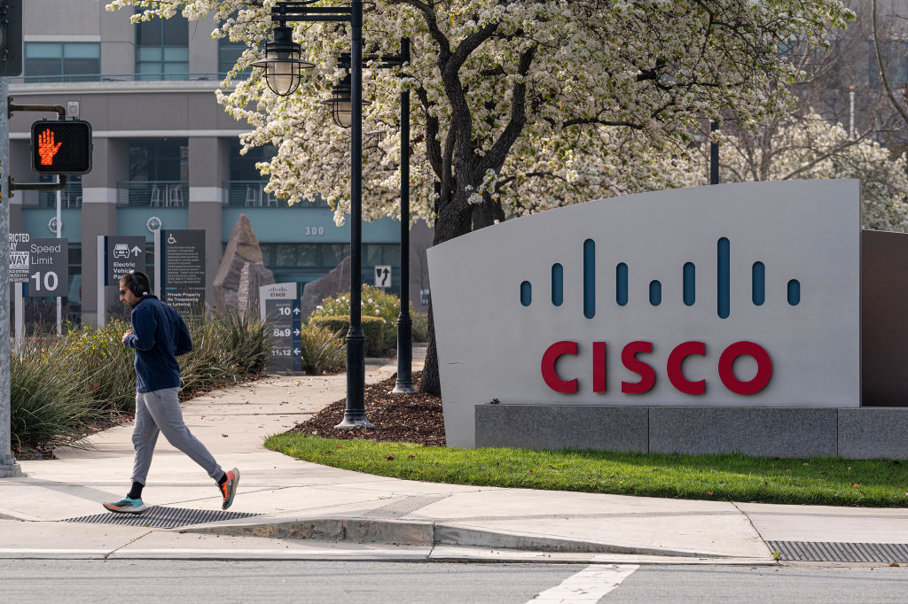 A runner jogs past Cisco Systems headquarters in San Jose, California, U.S., on Monday, Feb. 8, 2021.