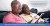 Two older people using a tablet computer together.