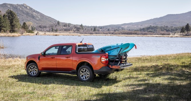 Ford Maverick hybrid truck parked by the side of a lake