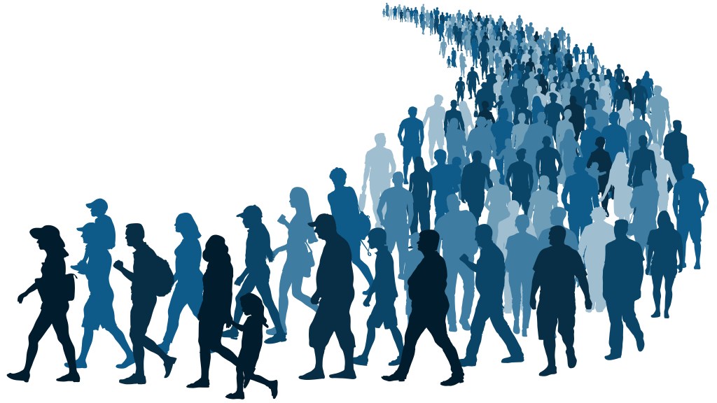 Image of a crowd of people waiting in line to represent refugees/immigration.