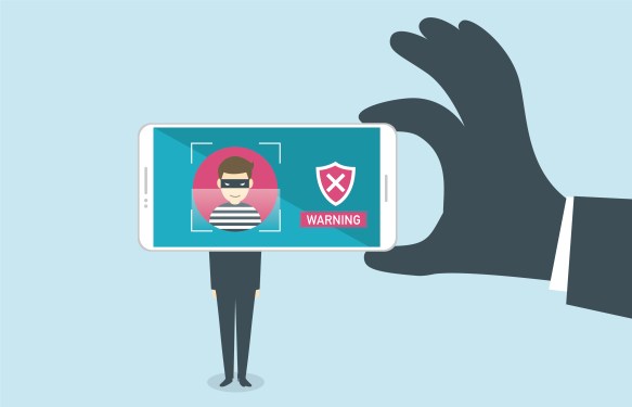 Image of a hand holding a phone showing a person behind the lens to be a fraudster.