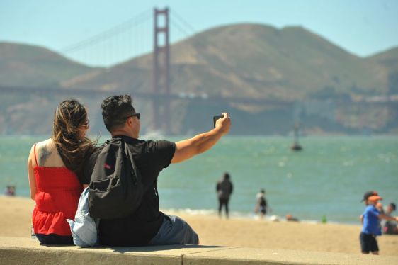 People enjoy their leisure time near the Golden Gate Bridge in San Francisco, California, the United States, June 15, 2021. California, the most populous state in the United States, fully reopened its economy amid dropping cases and vaccine eligibility expansion on Tuesday after more than a year of COVID-19 restrictions. (Photo by Liu Yilin/Xinhua via Getty Images)