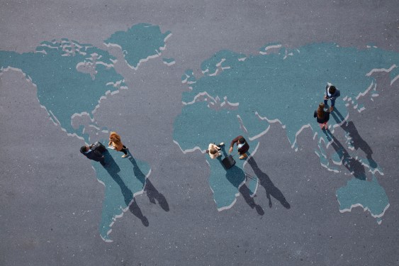 Group of young adults, photographed from above, on various painted tarmac surface, at sunrise.