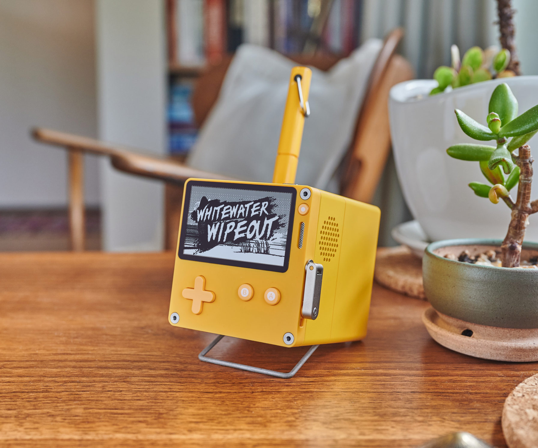 Playdate attached to its little cubical dock.