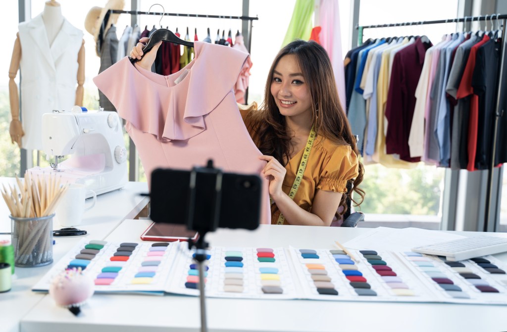 Fashion vlogger presenting clothes on an online live shopping platform