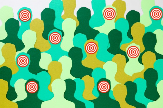 Image of silhouettes in shades of green with some marked with targets to represent facial recognition technology.