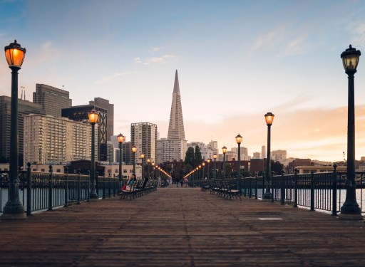 a view of Pier 7 along San Francisco's waterfront at dusk with the Transamerica Pyramid at the center in the background.