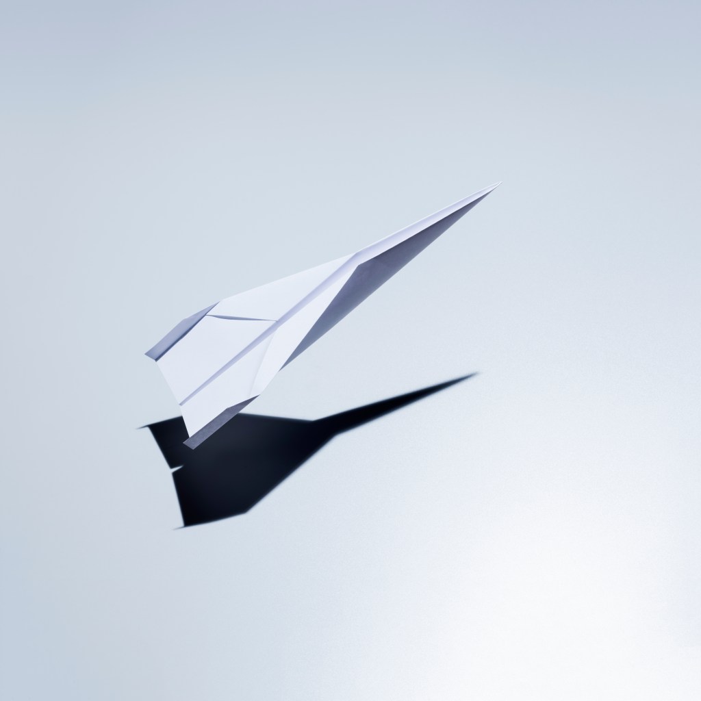 Image of a paper plane taking off.