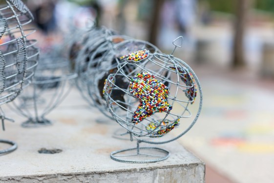 Image of a metallic globe with Africa made up of little beads.