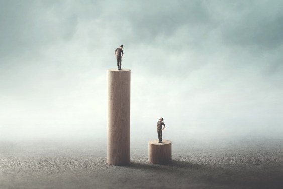 Image of two people standing on differently sized platforms to represent how venture capital fails to respect human rights.