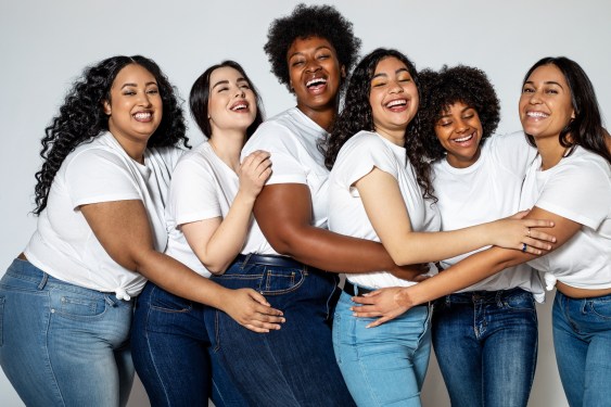 Image of a diverse group of women in white shirts and blue jeans to represent ​diversity in the digital tr​ansformation of the fashion industry. ​