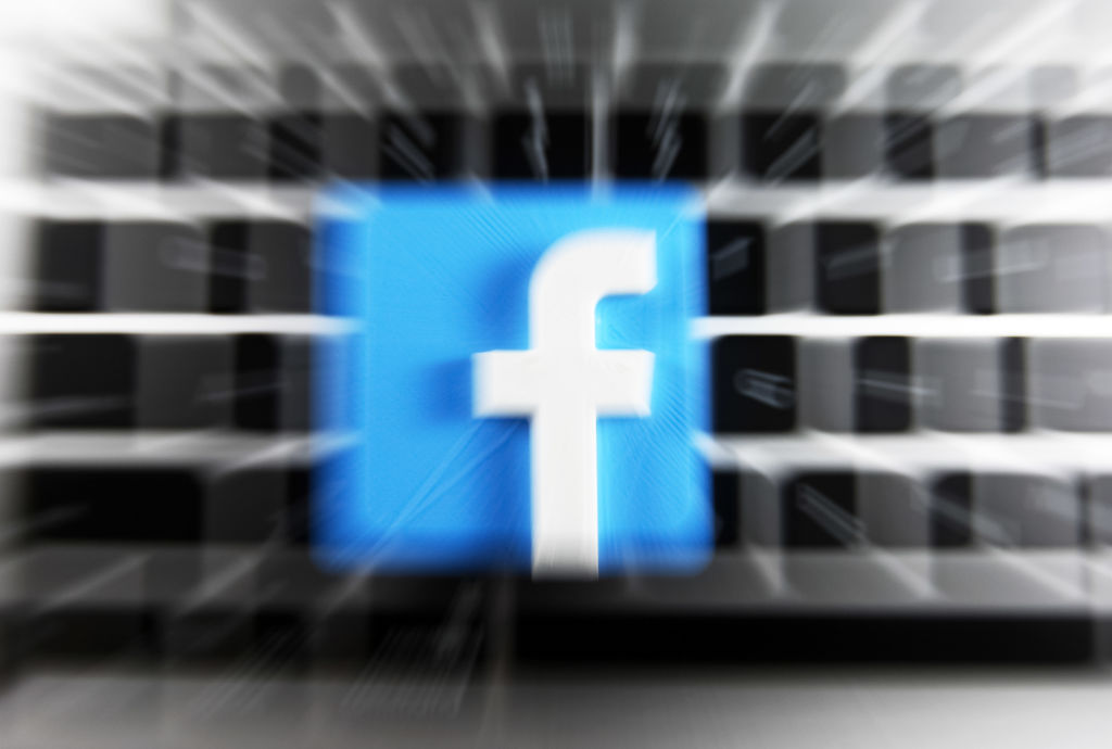 Facebook logo and a laptop are pictured in this illustrative photo in Kyiv on 29 July, 2021. (Photo by STR/NurPhoto via Getty Images)