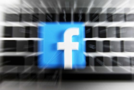 Facebook logo and a laptop are pictured in this illustrative photo in Kyiv on 29 July, 2021. (Photo by STR/NurPhoto via Getty Images)