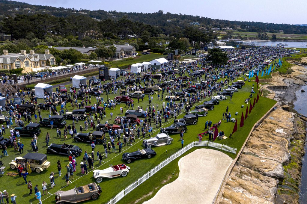 Attendees gather around vehicles at the 2021 Pebble Beach Concours d'Elegance in Pebble Beach, California, U.S., on Sunday, Aug. 15, 2021.