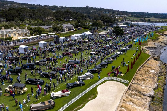 Attendees gather around vehicles at the 2021 Pebble Beach Concours d'Elegance in Pebble Beach, California, U.S., on Sunday, Aug. 15, 2021.