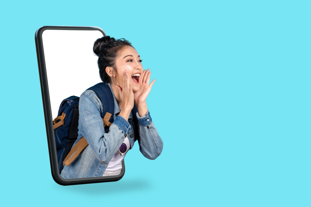 Image of a woman popping out of a cell phone against a blue background.