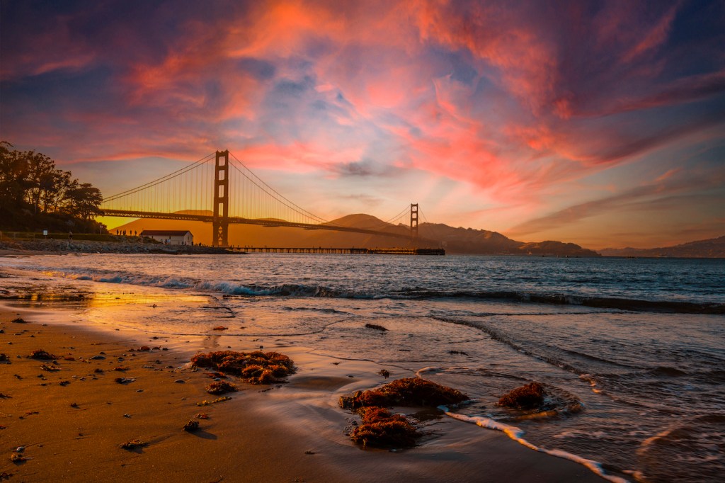 Gorgeous orange sunset with pink clouds over the Golden Gate in San Francisco, California. United States