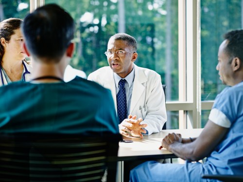 Image of a doctor consulting in a meeting to represent health tech advisory boards.