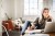 Image of an older woman sitting in front of a laptop working from home.