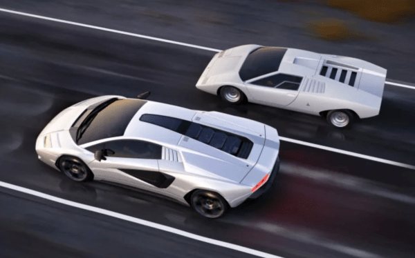 2 Lamborghinis side by side driving down a highway