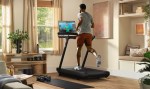 Peloton Tread, man running on the treadmill while watching workout video