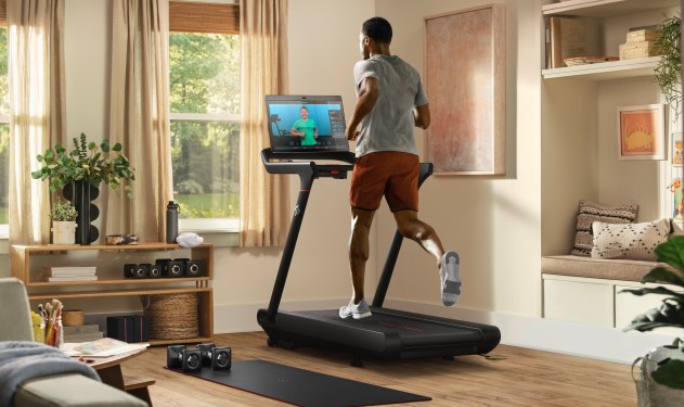 Peloton Tread, man running on the treadmill while watching workout video