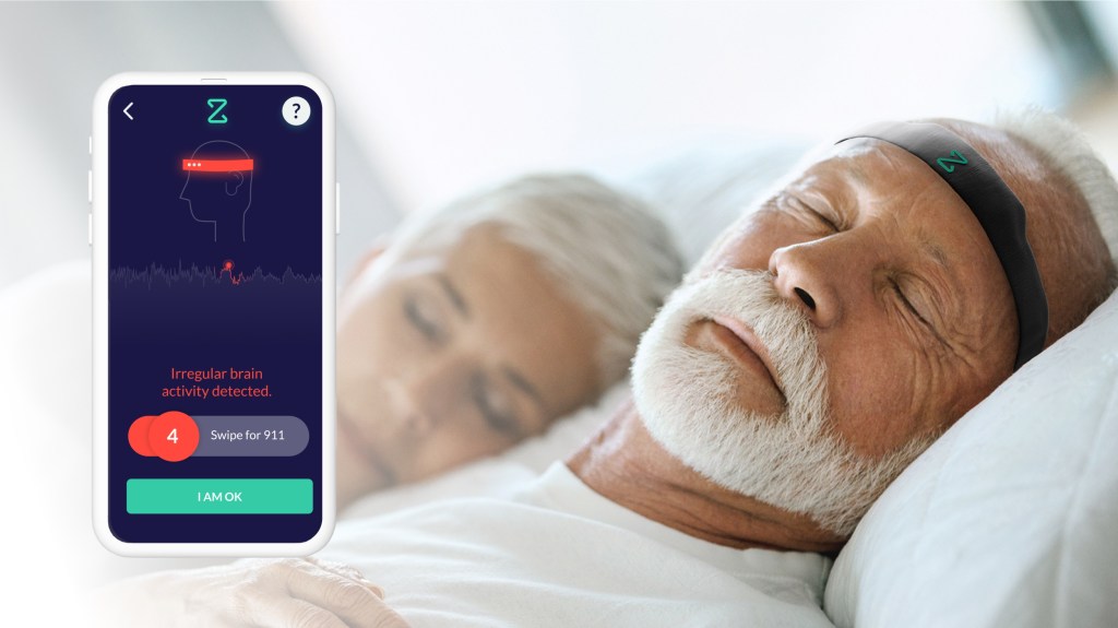 A bearded man wears a Zeit headband in bed, and an app alerts him of abnormal brain activity.