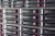 Array of hard drives in a computer data center server rack with plugs for LAN cables above in a close up detailed full frame view in a cloud computing concept