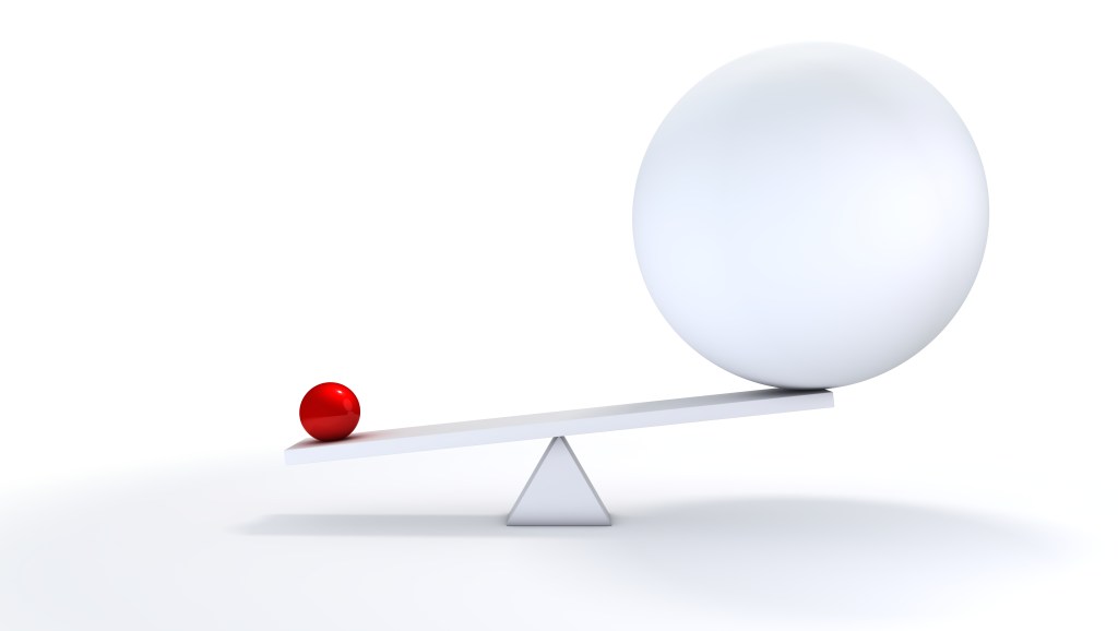 Image of a small ball and a large ball on a seesaw to represent anticompetitive business practices.