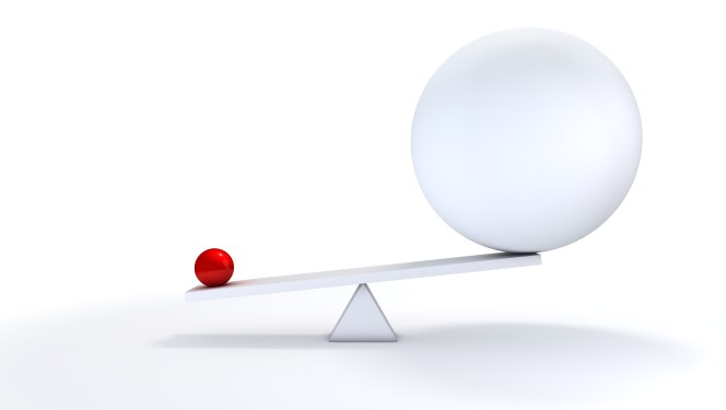 Image of a small ball and a large ball on a seesaw to represent anticompetitive business practices.