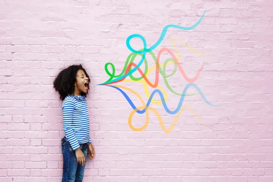 Image of a girl shouting against a brick wall painted pink with multicolored squiggles on the wall to represent her voice.