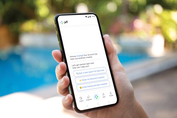A photo of a person's hand holding a smartphone with Jeff App open