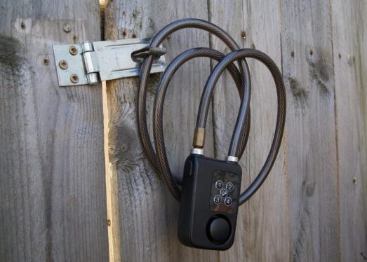 Nymbull smartlock attached to a wooden fence.