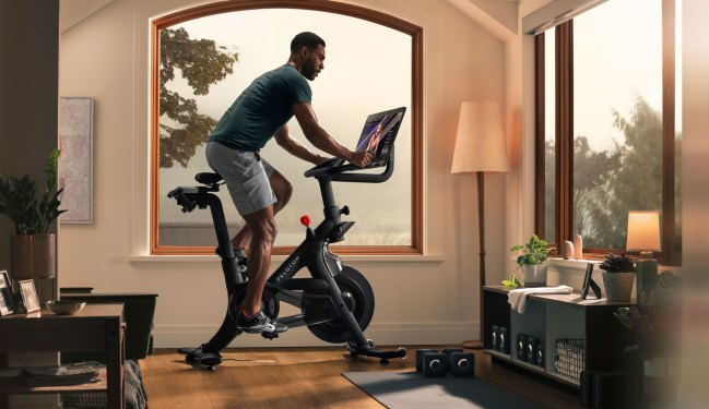 Person riding Peloton bike plus, living room