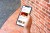 A closeup of a hand holding a smartphone opened to Headout's travel activity booking app