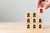 Image of a hand selecting a block with a person painted on it from eight other blocks.