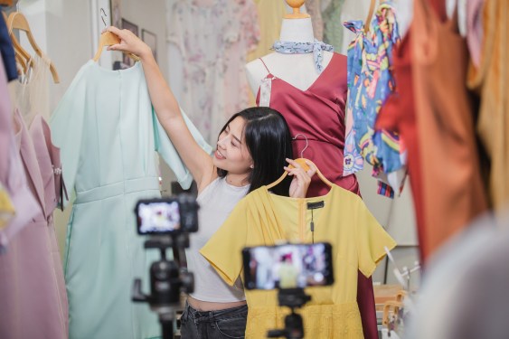 Photo of a woman selling clothes on a livestream