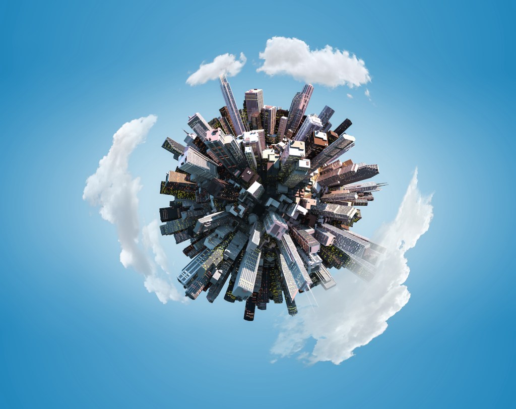 Miniature city planet on blue sky background