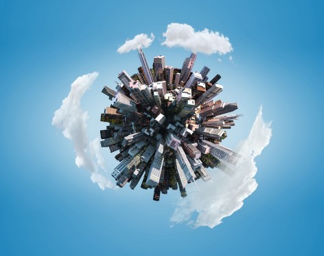 Miniature city planet on blue sky background