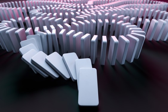 White Domino Pieces Pushing the Domino Effect.
