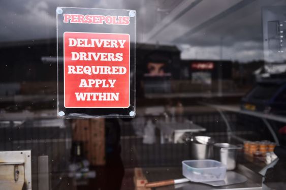BURSLEM-ENGLAND- MARCH 15: A job sign advertising Delivery Drivers required is displayed outside Persepolis takeaway shop on March 15, 2021 in Burslem, England. (Photo by Nathan Stirk/Getty Images)