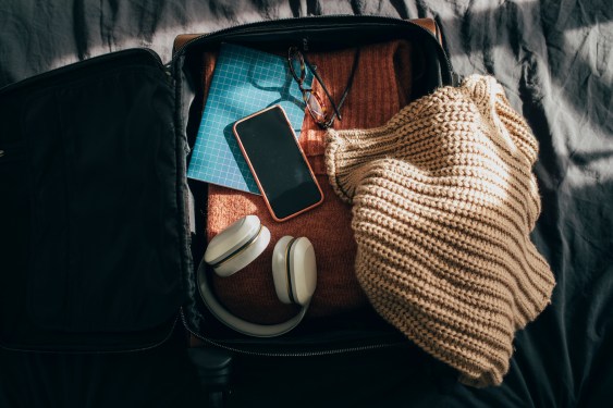 Packing up suitcase for vacation and preparing for a journey, flat lay