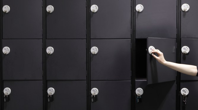 Hand opening empty dark locker
