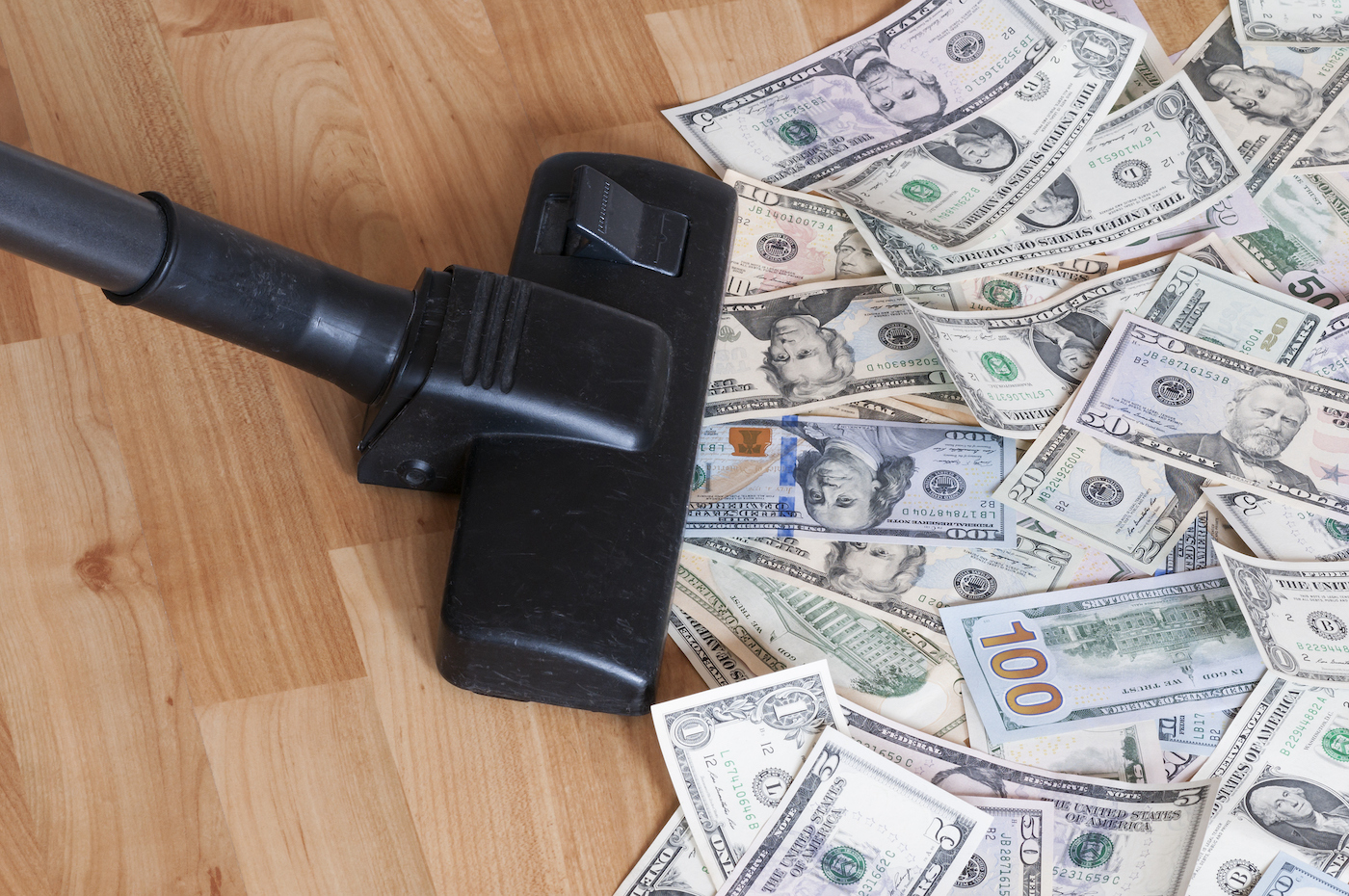 Vacuum cleaner sucks up a pile of US $100 bills