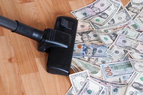 Vacuum cleaner sucks up a pile of US $100 bills